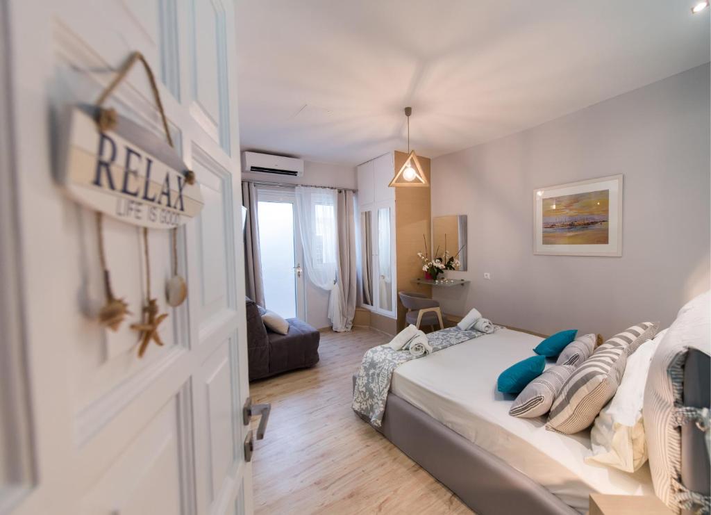 雷夫卡达镇LEFKAS CITY APARTMENTS & SUITES的一间卧室设有一张床和一间客厅。