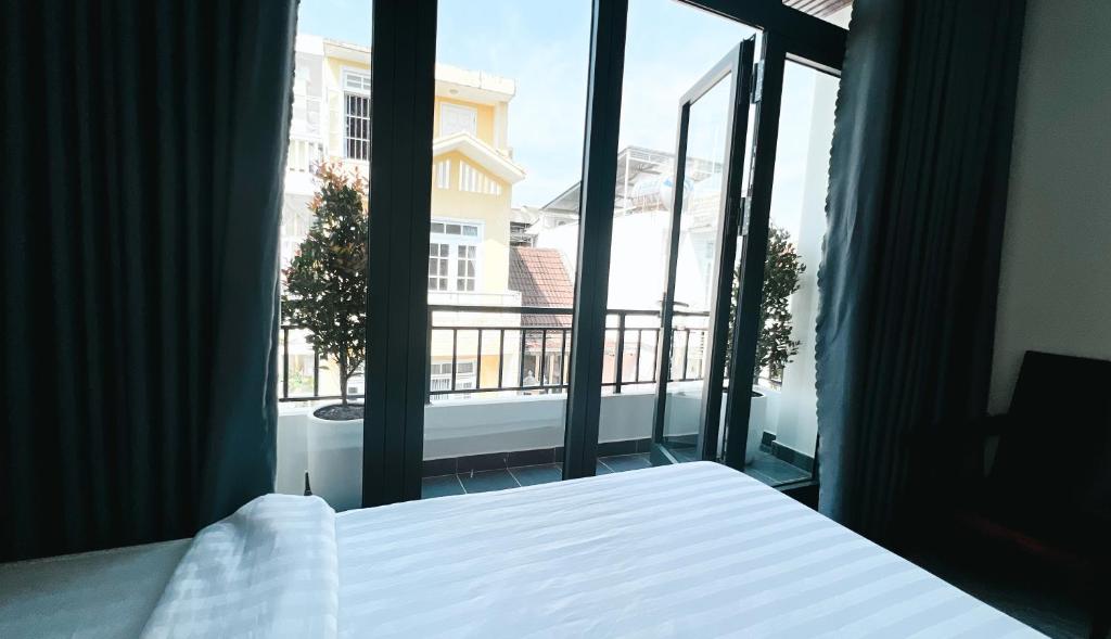 顺化Mini hotel Lạc Hồng的一间卧室设有一张床和一个大窗户
