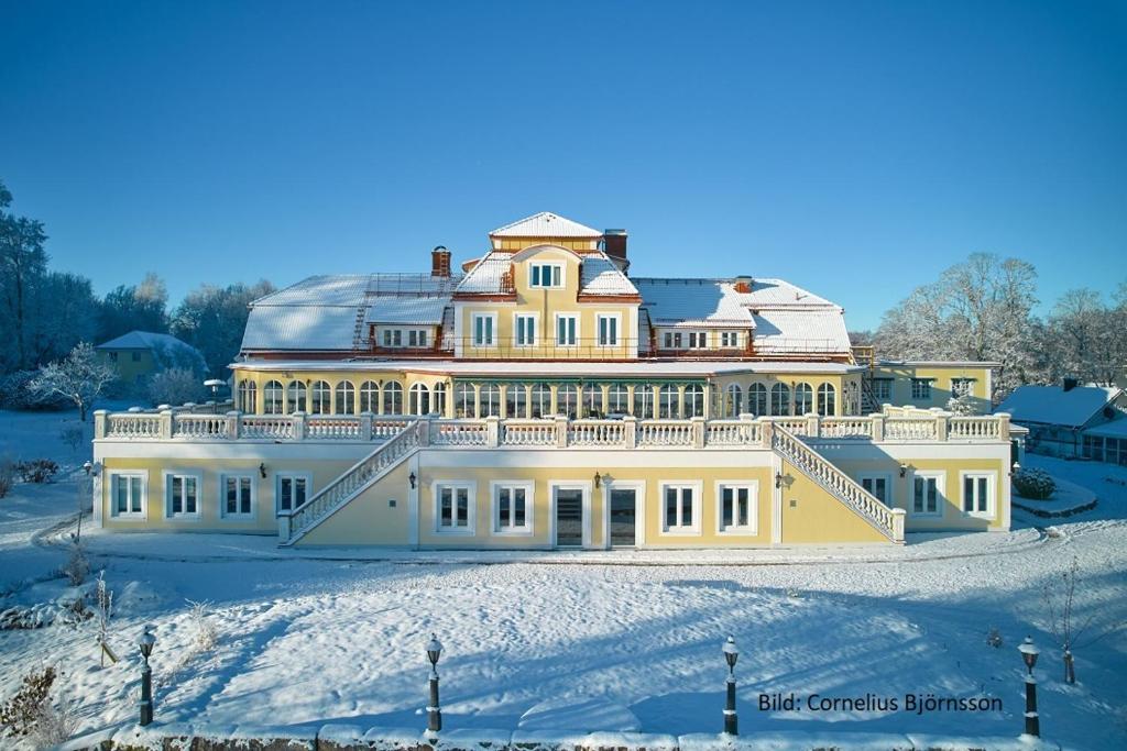 DiöMöckelsnäs Herrgård的雪中一座白色的大宅邸