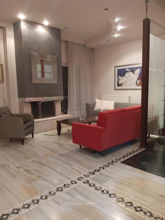 特里卡拉Elegante apartamento centrale的客厅设有红色的沙发和壁炉