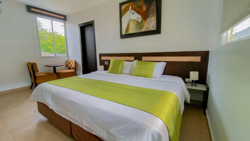 瓜亚基尔MC Suites Boutique的一间卧室配有一张带绿毯的大床