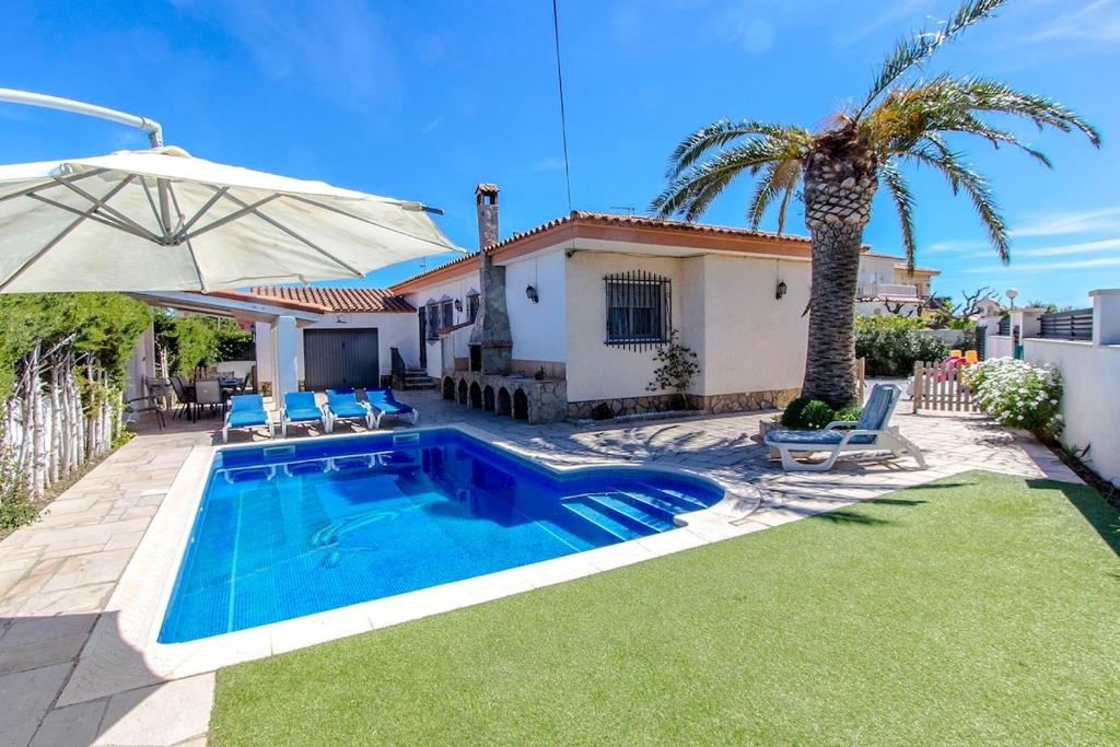 霍斯皮塔勒·德尔英福Catalunya Casas Beach Vibes Villa less than 1km to town and sea!的一座别墅,设有游泳池和棕榈树