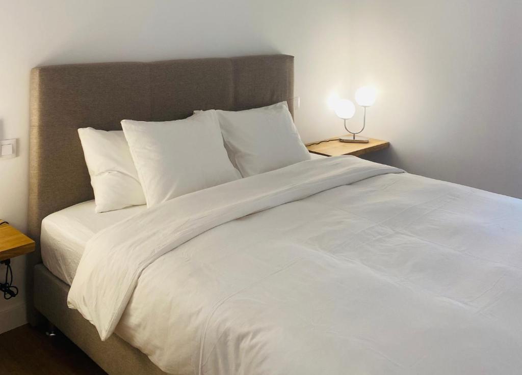 马略卡岛帕尔马Hotel Apartment with 2-en suite Bedrooms的一张白色大床,配有白色床单和枕头