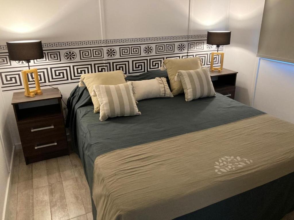 罗尔丹Monte Aromas的一间卧室配有一张大床,上面有两盏灯
