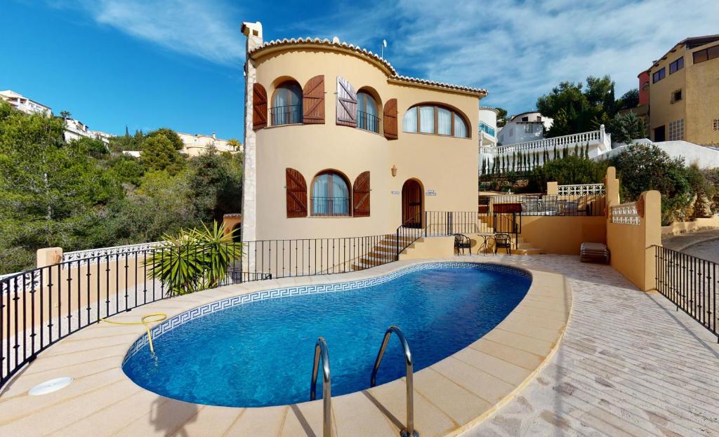 库姆布勒德尔索尔Villa Encinas的别墅前设有游泳池
