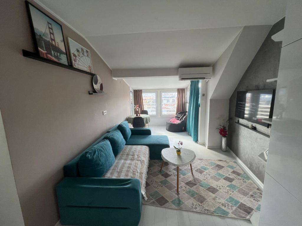 克尔贾利Town Place Apartment的客厅配有蓝色的沙发和桌子