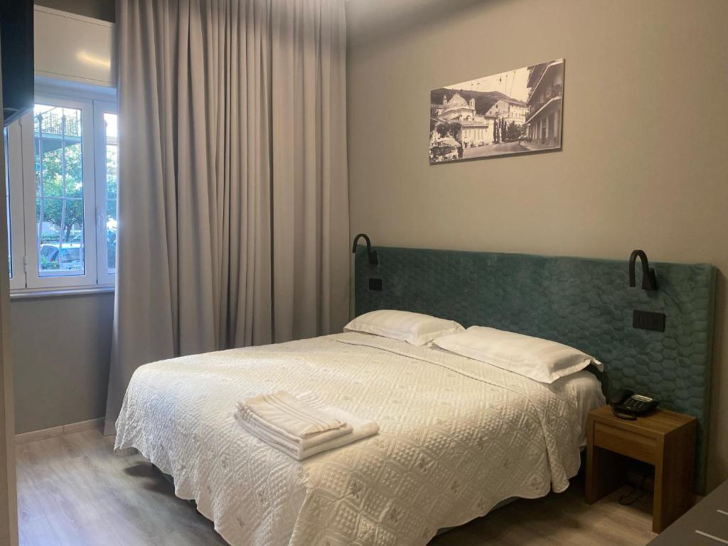 阿尔玛·迪·塔吉亚Hotel Graziella的一间卧室配有一张床,上面有两条毛巾