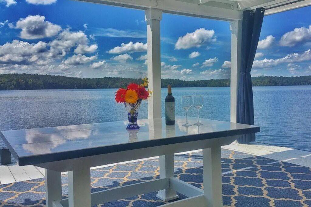 WinchesterMillion Dollar Views: Lakefront, Dock, Kayaks+More的一张桌子,上面放着花瓶和一瓶葡萄酒