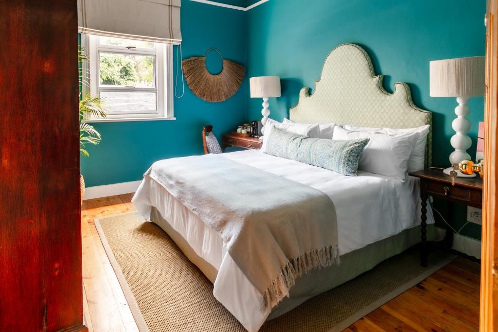 弗朗斯胡克The Belmont的一间卧室配有一张蓝色墙壁的床