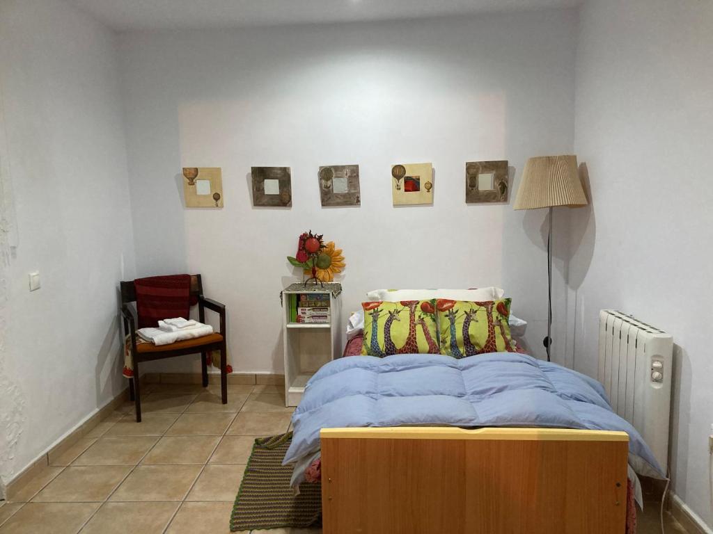 普拉森西亚La Casina Apartamento Turistico centro Plasencia AT-CC-0650的一间卧室配有一张床、一张桌子和一盏灯