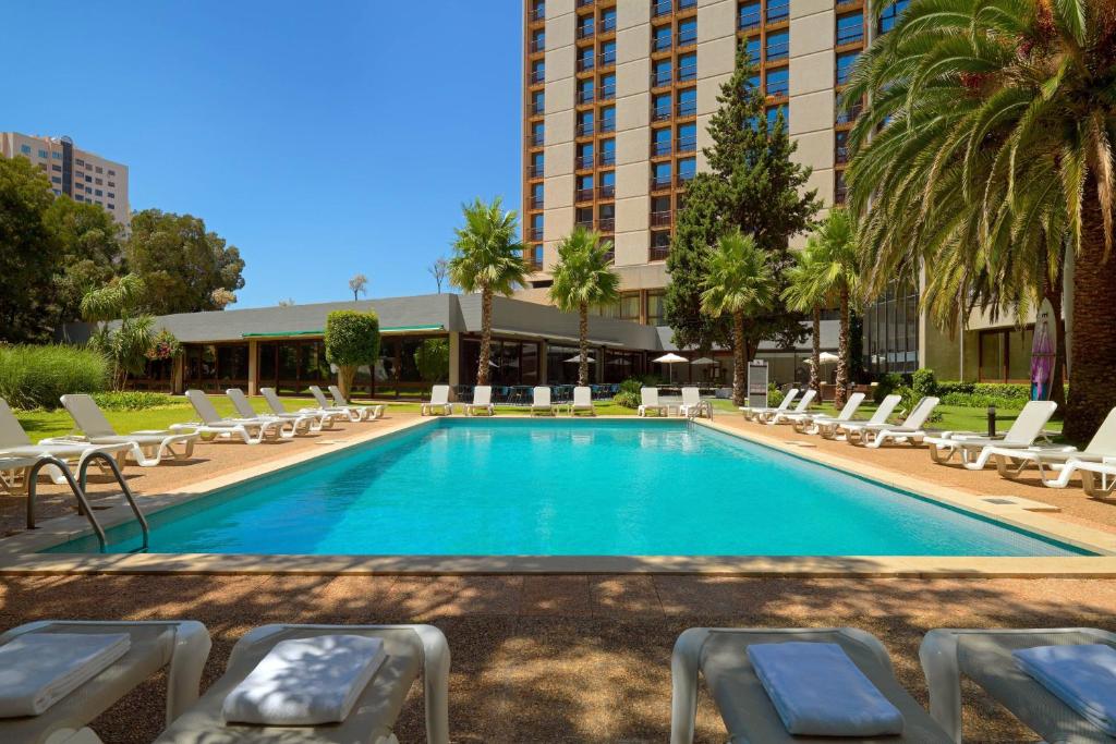 里斯本里斯本万豪酒店的一个带躺椅的游泳池和一间酒店