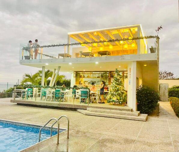 通苏帕Vacaciones Playa Azul的一座带游泳池的房子,阳台上有人