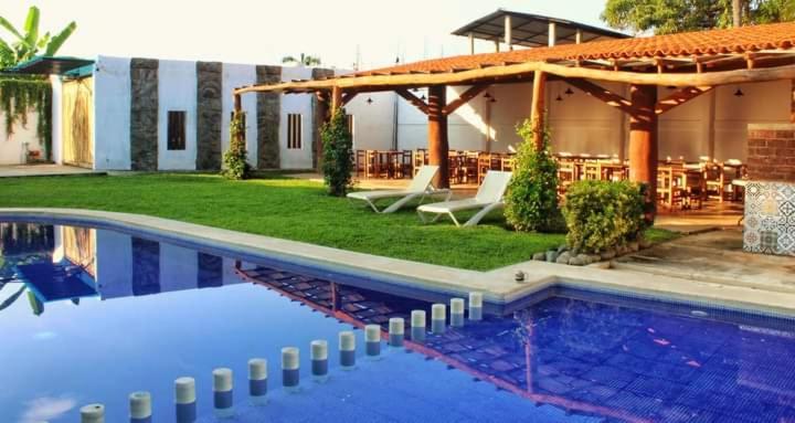 锡瓦塔塔内霍BM Zihua Casa de Huéspedes的一个带游泳池和餐厅的一个度假胜地
