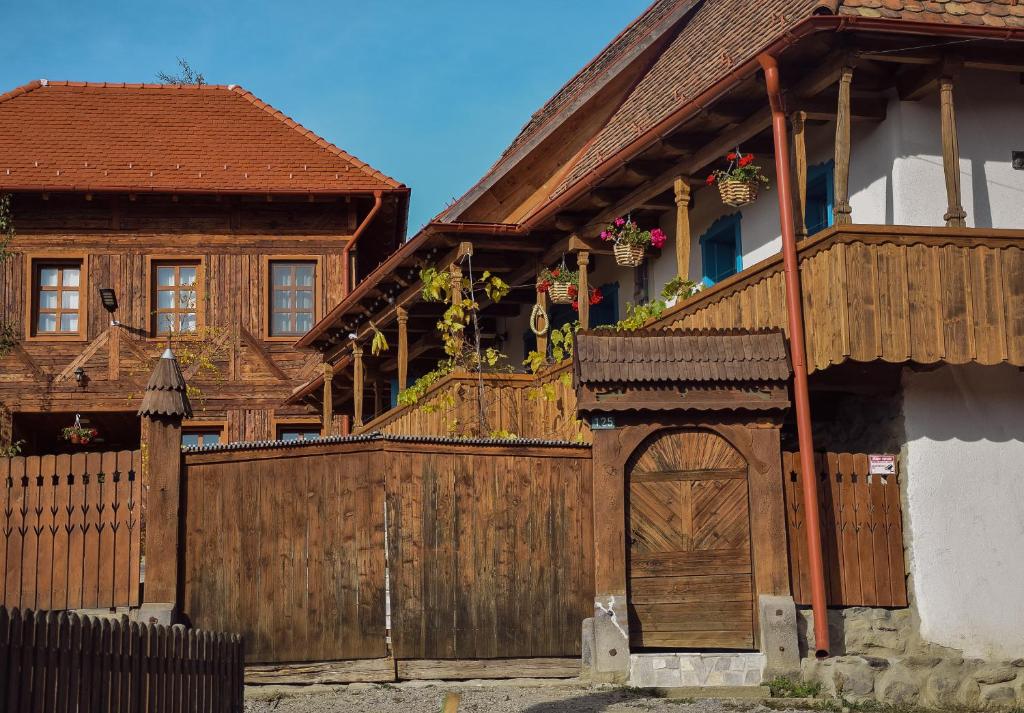 BartoştanaSzékelyföld ,Siklódi Kő Vendégház, Tornácosház的一座带木门和围栏的房子