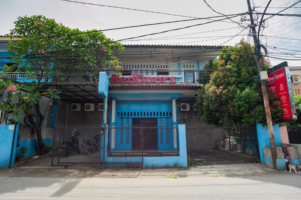 Kemirimuka DuaRedDoorz near Margonda Raya的蓝色的建筑,上面有标志