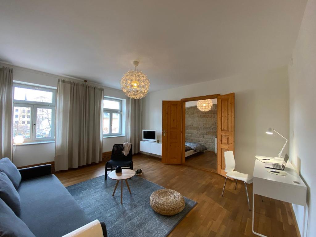 德累斯顿Apartments Dresden Neustadt Apartment LOUISE的客厅配有蓝色的沙发和桌子
