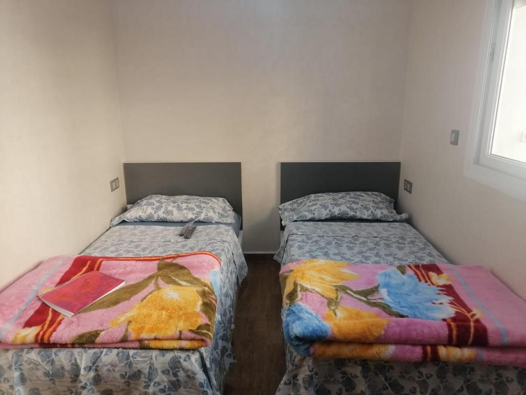 阿加迪尔hay adrar 2 agadir Morocco的小型客房配有两张床,