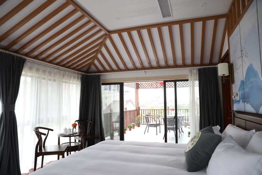 上海恬园佳舍海昌海洋公园滴水湖店的一间卧室设有一张床和一个阳台