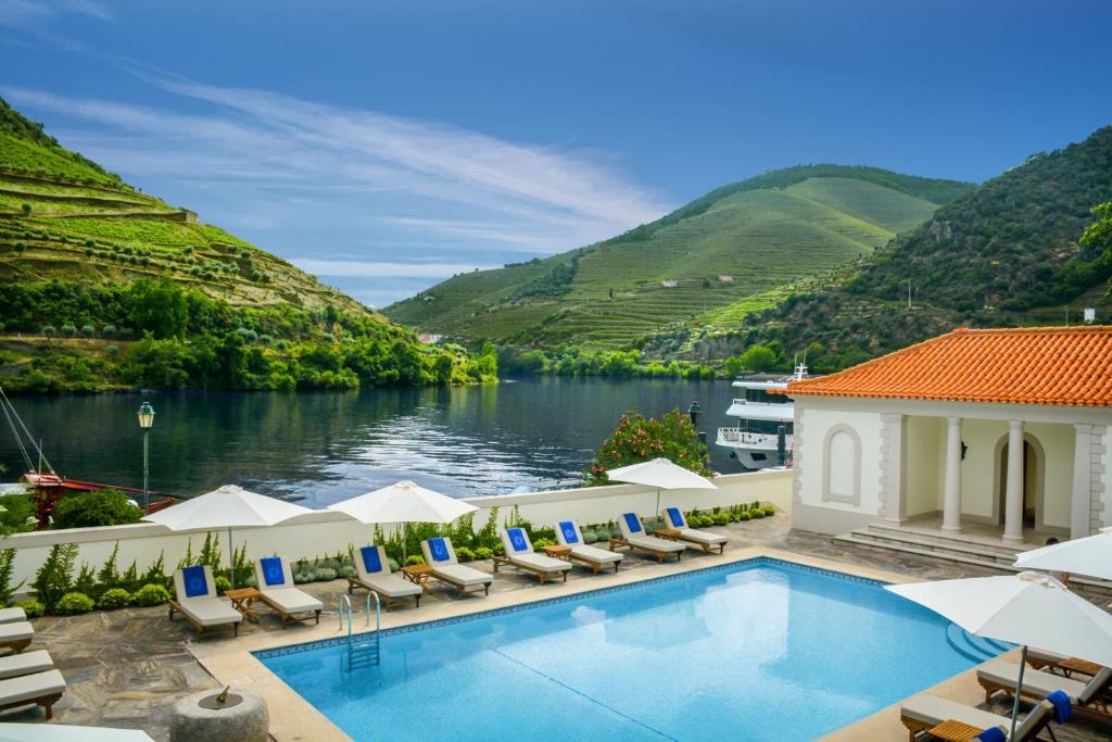 皮尼昂杜罗复古之家酒店的游泳池配有椅子,享有河流和山脉的美景