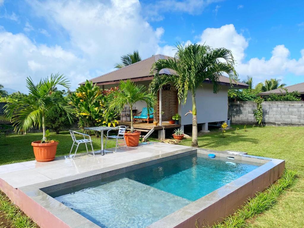 TaravaoTAHITI - Fare Matavai Piti的一个带游泳池和房子的后院
