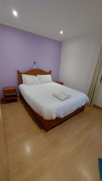 法鲁康达住宅旅馆的一间卧室配有一张带白色床单的大床