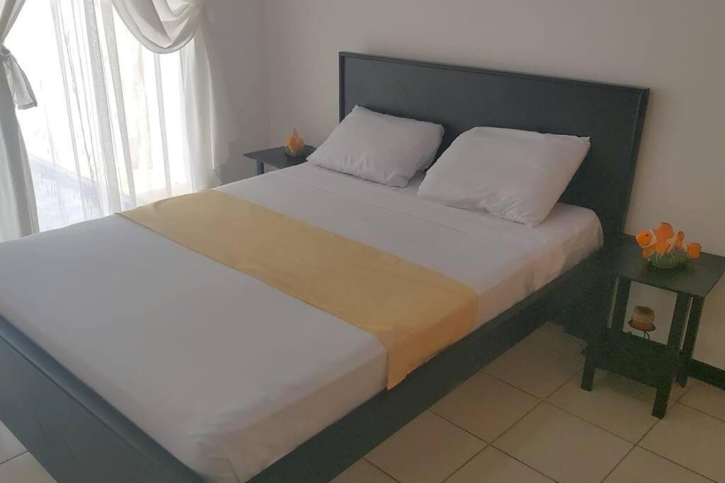 赫拉多拉Casa vacacional Playa Herradura的一间卧室配有一张大床和黑色床头板