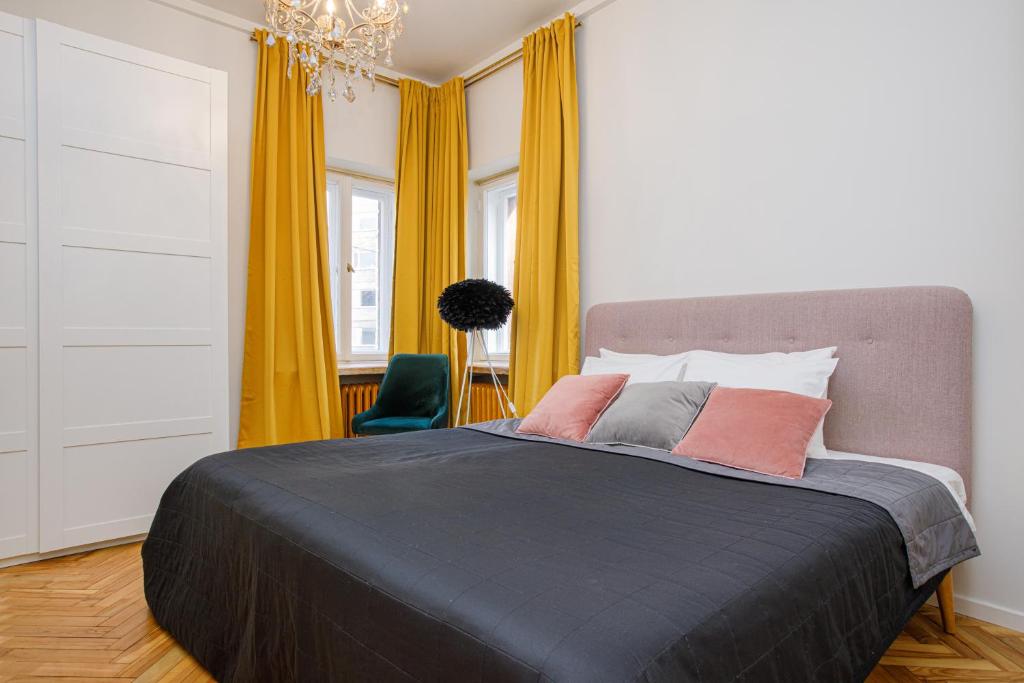 塔林Apartment Peegel in city center free parking的一间卧室配有大床和黄色窗帘