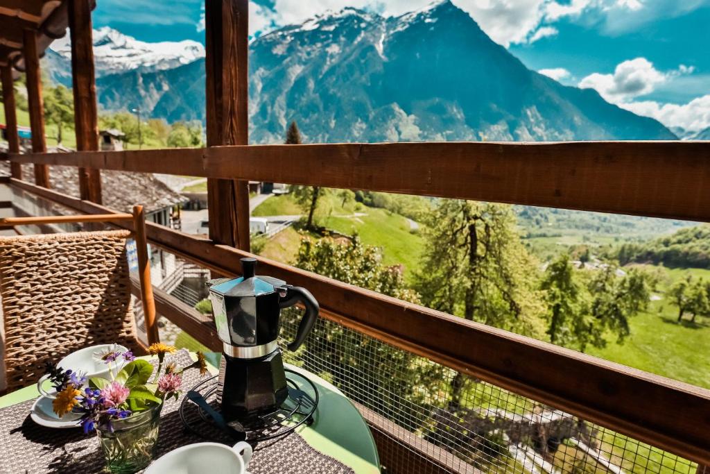 CastroAttico Adula的山景阳台上的桌子上的咖啡壶
