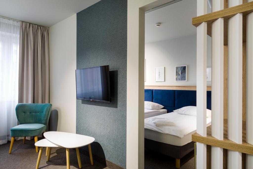 托伦Halo Toruń的一间酒店客房,配有一张床和一台电视