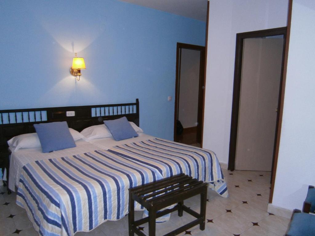 昆卡君悦大马路旅馆的一间卧室设有一张蓝色墙壁的大床