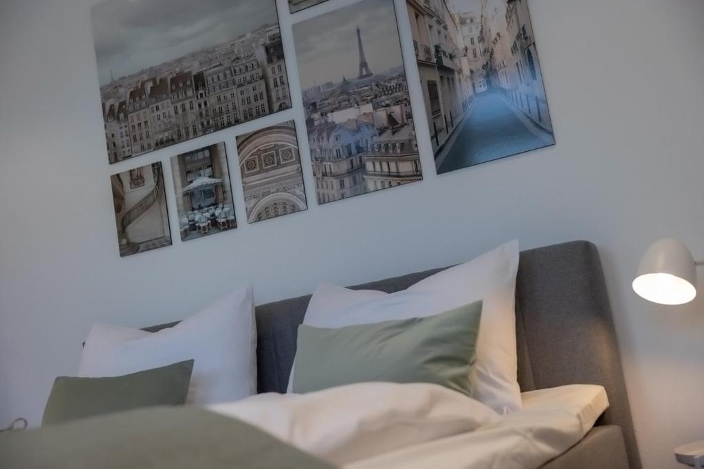 奥格斯堡Kaza Guesthouse, centrally located 2 & 3 bedroom Apartments in Augsburg的客厅配有沙发和墙上的照片