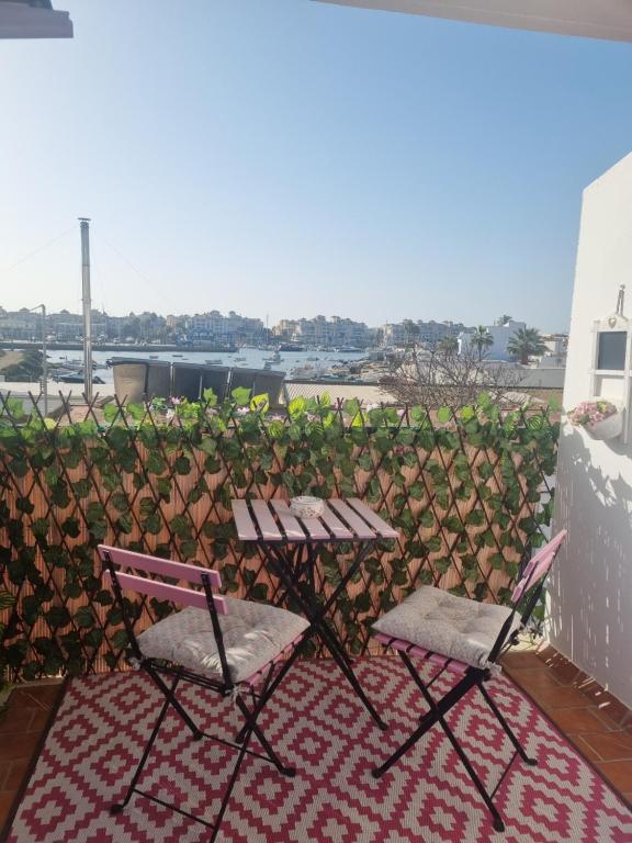 莫拉尔岛Sol y Luz的阳台上配有两把椅子和一张野餐桌