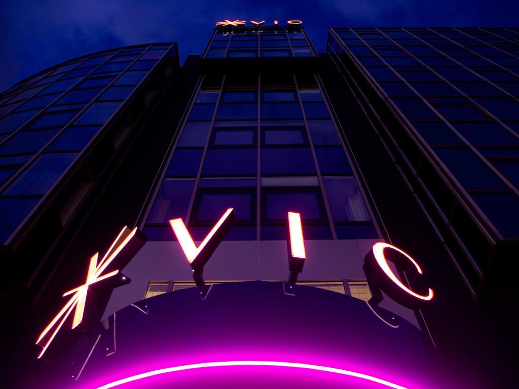 莱顿Hotel VIC的前面有 ⁇ 虹灯标志的建筑