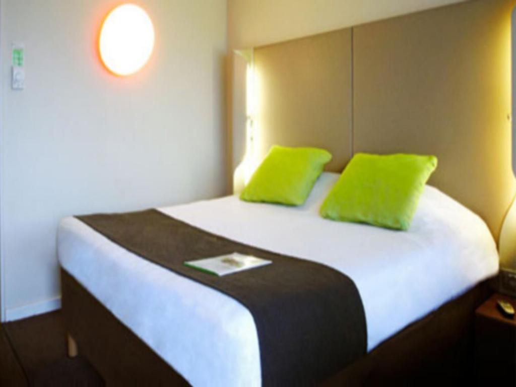 莫内托钟楼奥克斯尔莫内托酒店的一张带两个石灰绿色枕头的床