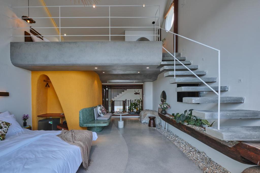 会安Barbados Cherry Villa的卧室配有床,楼梯位于房子内
