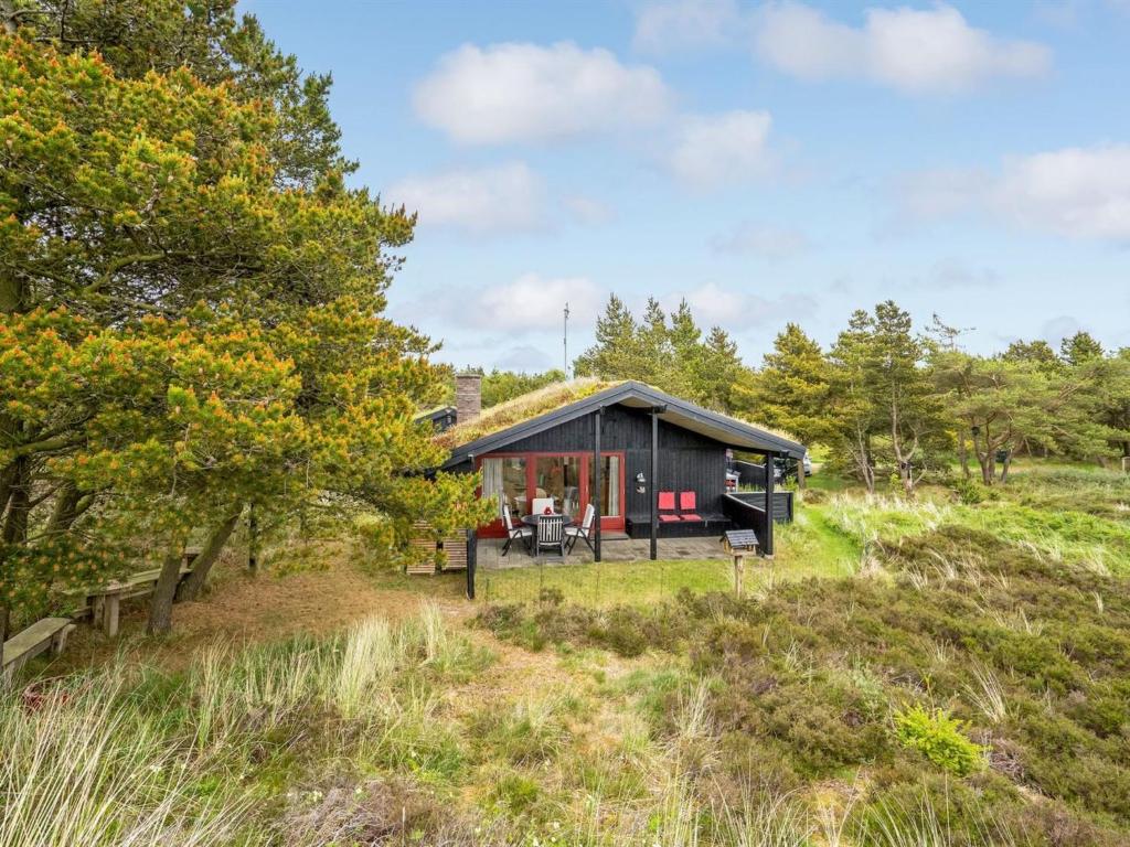 博利尔马克Holiday Home Kathaline - 3-4km from the sea in Western Jutland by Interhome的树林中带草屋顶的小屋