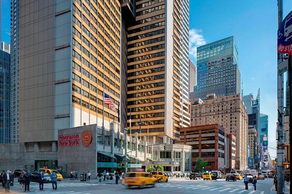 纽约纽约时报广场喜来登酒店的一条繁忙的城市街道,街道上有很多汽车和人,建筑
