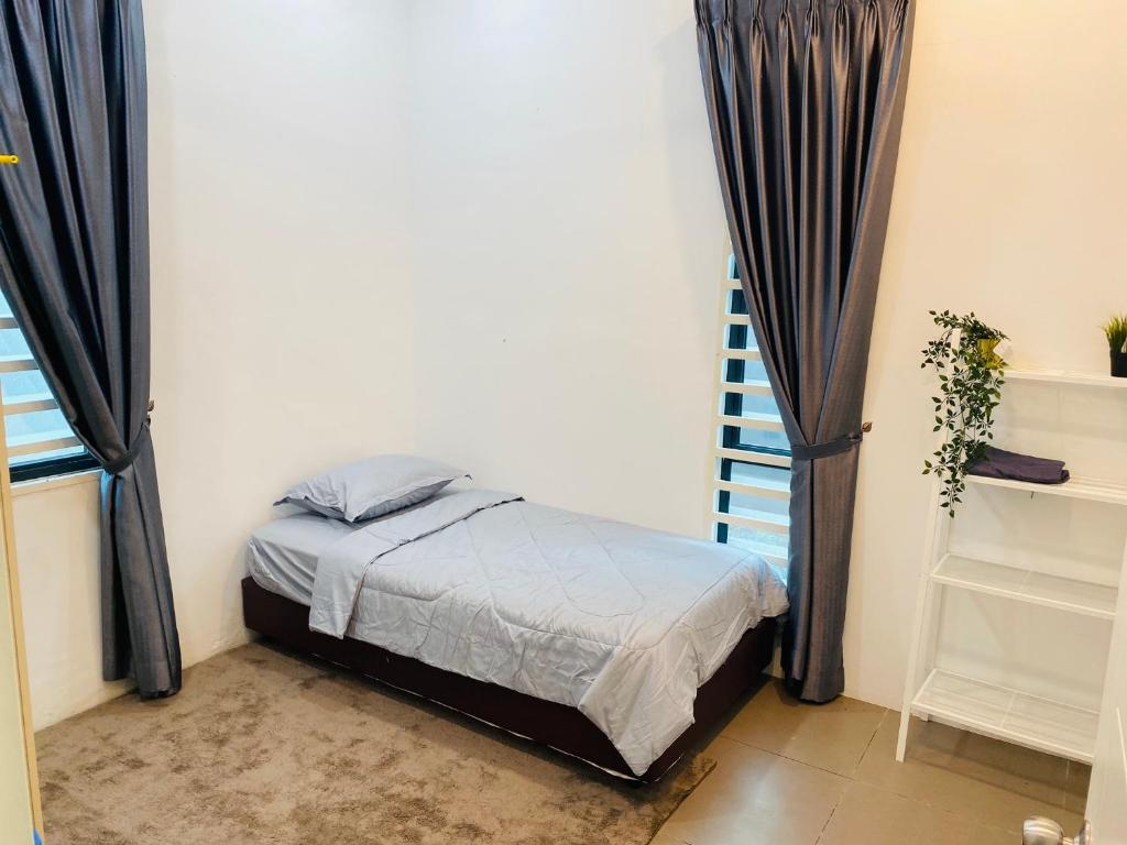 阿罗士打Homestay Alor Setar Nearby Hospital Sultanah Bahiyah的一间带床的卧室,位于带窗帘的房间