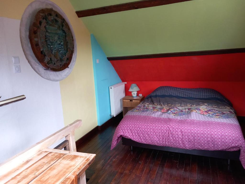 莫伯日maison d'artiste accès jardin的一间卧室配有一张红色床头板的床