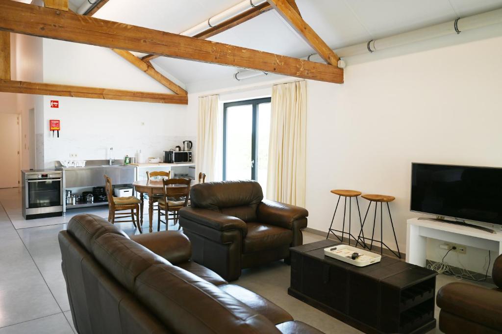 霍尔斯贝克Landlord bij Leuven的客厅配有沙发、椅子和桌子