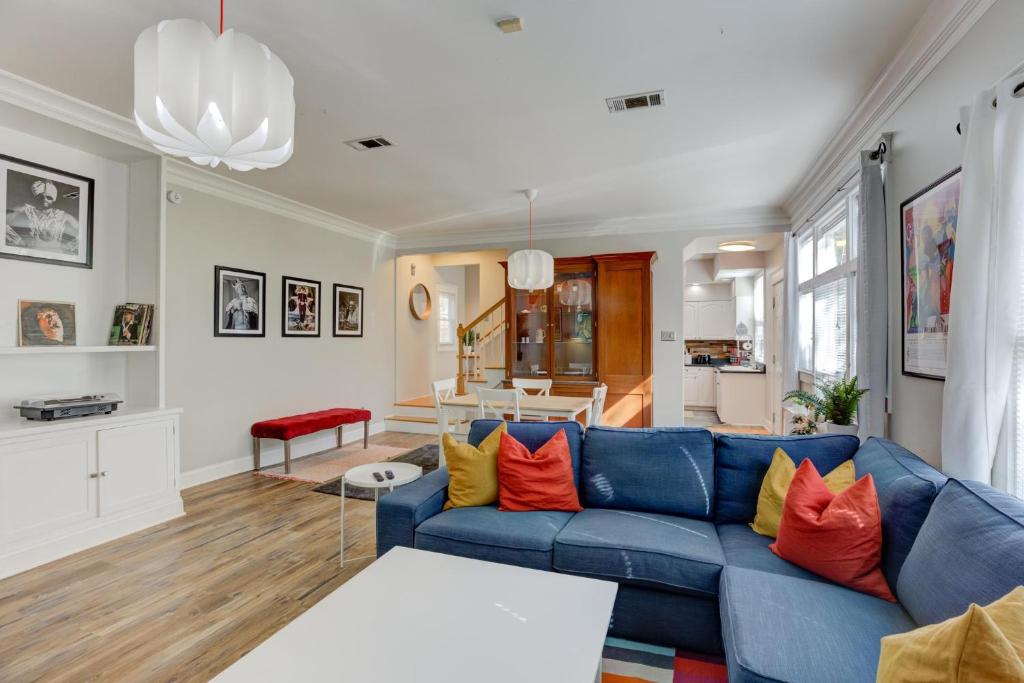 孟菲斯Hip and Spacious Midtown Cottage near Beale Street的客厅配有蓝色沙发和橙色枕头。