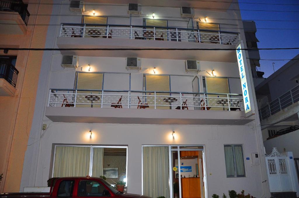 锡蒂亚诺拉酒店的白色的建筑,带有灯光的阳台