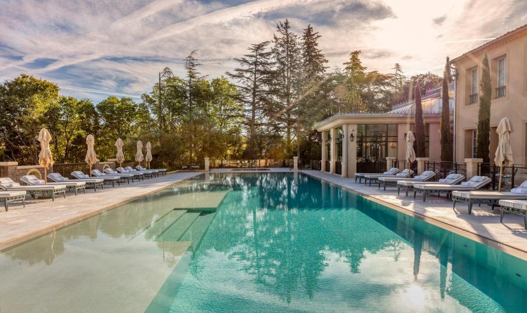 普罗旺斯艾克斯Villa Saint-Ange的一座带躺椅的游泳池和一座建筑