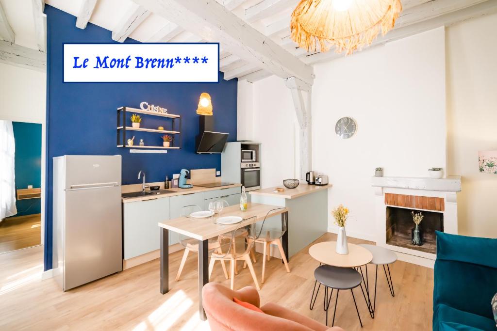 欧塞尔Le Mont Brenn的厨房以及带桌椅的起居室。