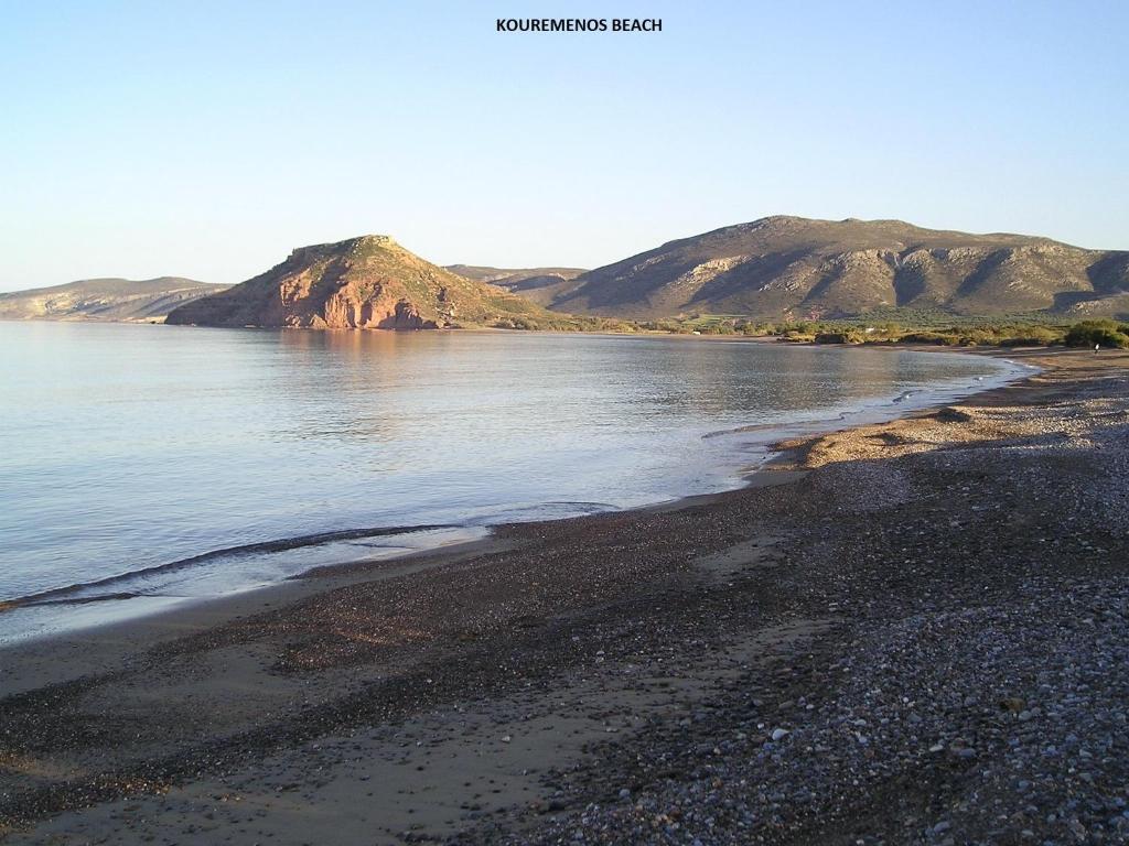 古卡斯特隆Kouremenos Beach Apartments的享有海滩美景,背景为群山