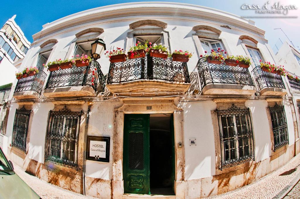 法鲁卡萨德阿拉戈阿旅馆的一座古老的建筑,设有两个种有鲜花的阳台