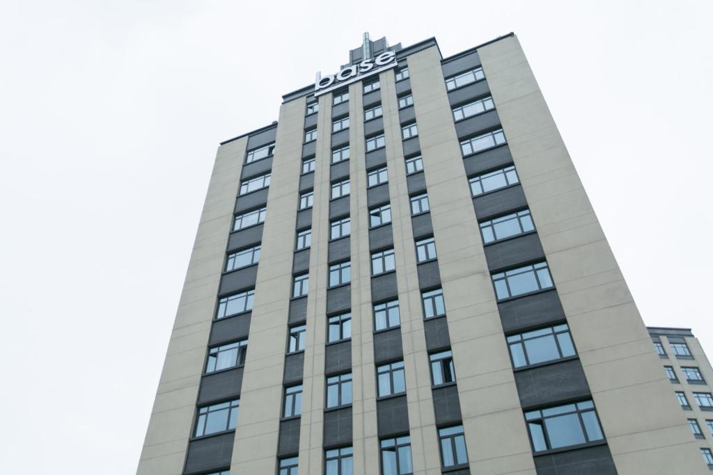 上海Base佰舍服务式公寓（上海浦三路店）的一座高大的建筑,上面写着酒店字