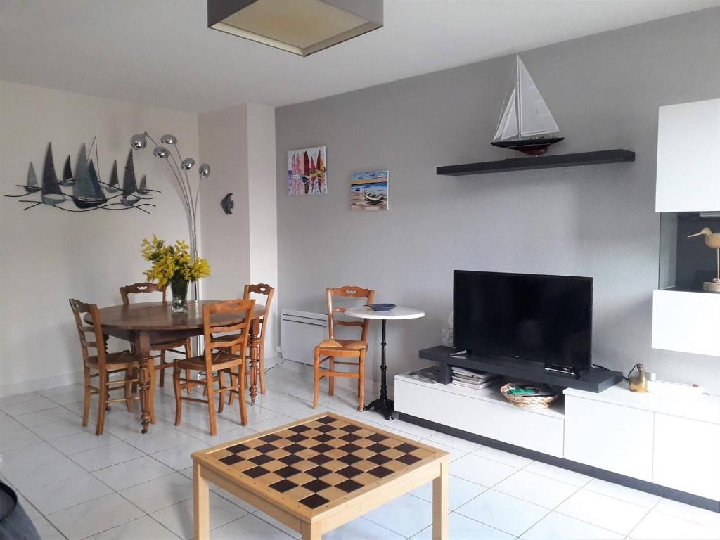 佩罗斯-吉雷克Appartement Perros-Guirec, 3 pièces, 4 personnes - FR-1-368-167的客厅配有桌子和国际象棋棋盘