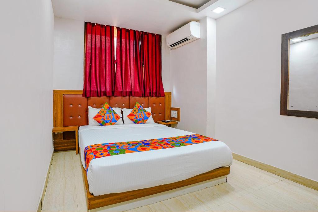孟买FabExpress Diamond I的一间卧室设有一张大床和红色窗户