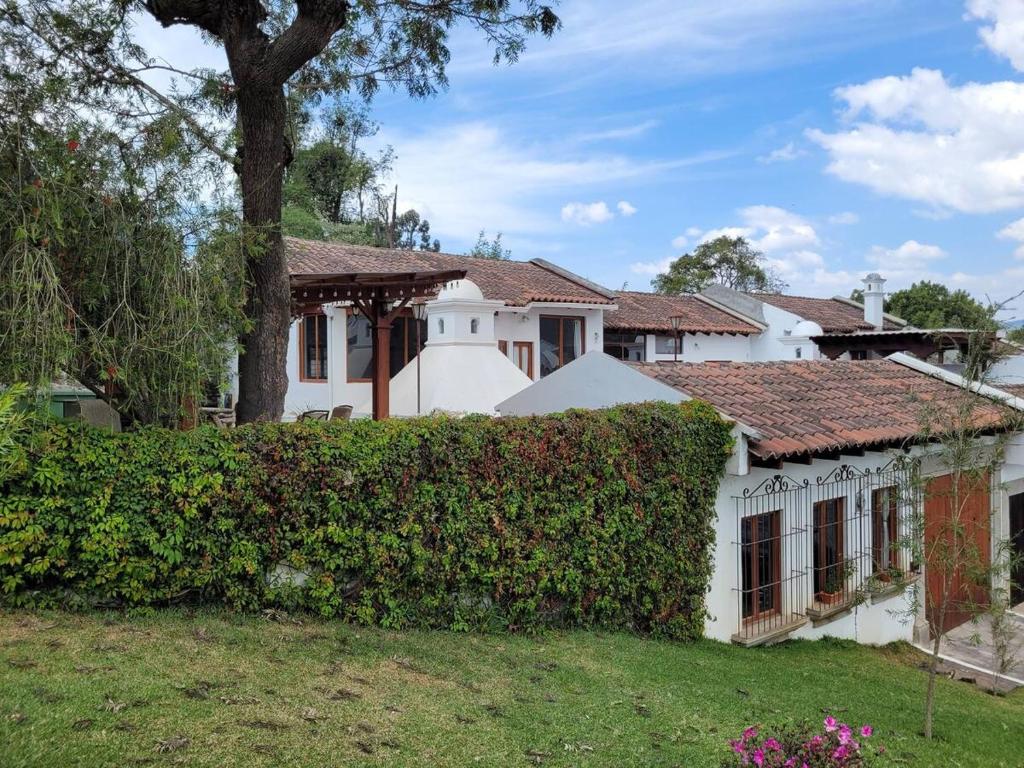 危地马拉安地瓜Amplia casa Antigua Guatemala con pérgola y jardín的前面有 ⁇ 的白色房子